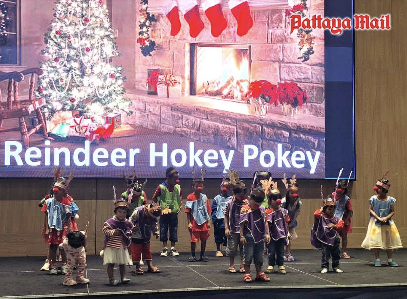 Hand to Hand children performing the Reindeer Hokey Pokey on stage at the Pattaya City Expats Club Christmas program