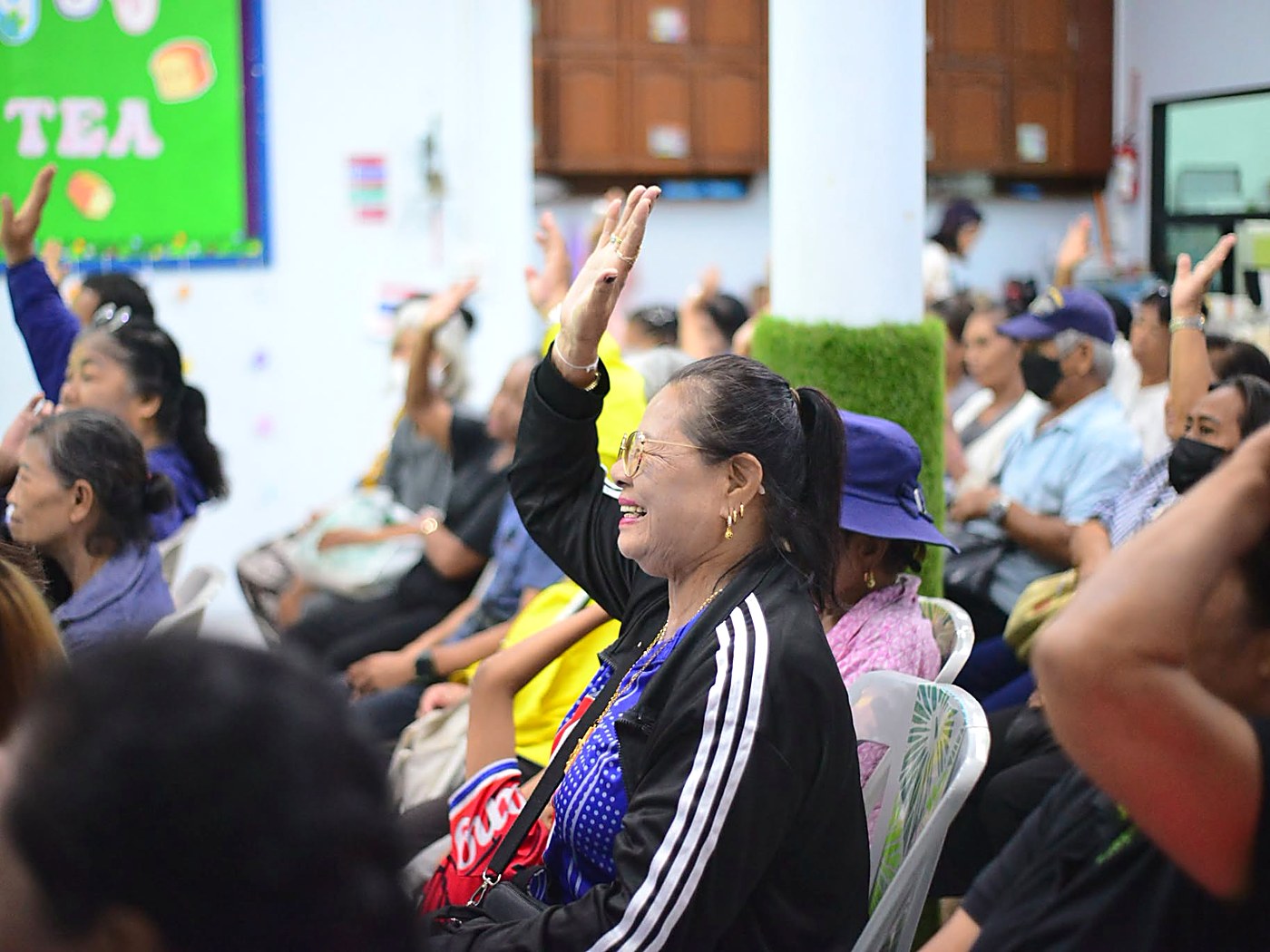 Members of the Hand to Hand church community worshipping together with hands raised