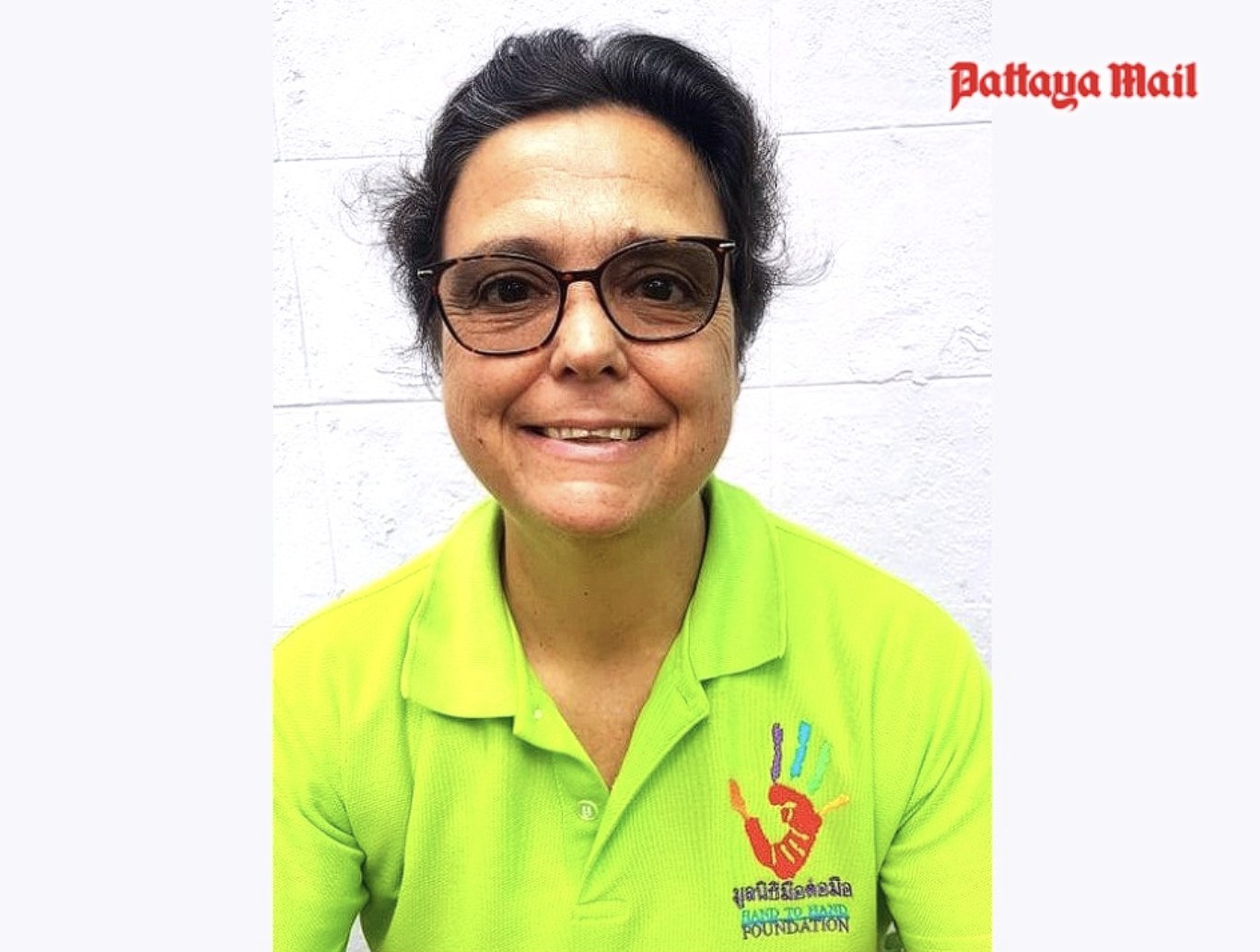 Margie Grainger, founder of Hand to Hand Foundation, wearing a Hand to Hand polo shirt