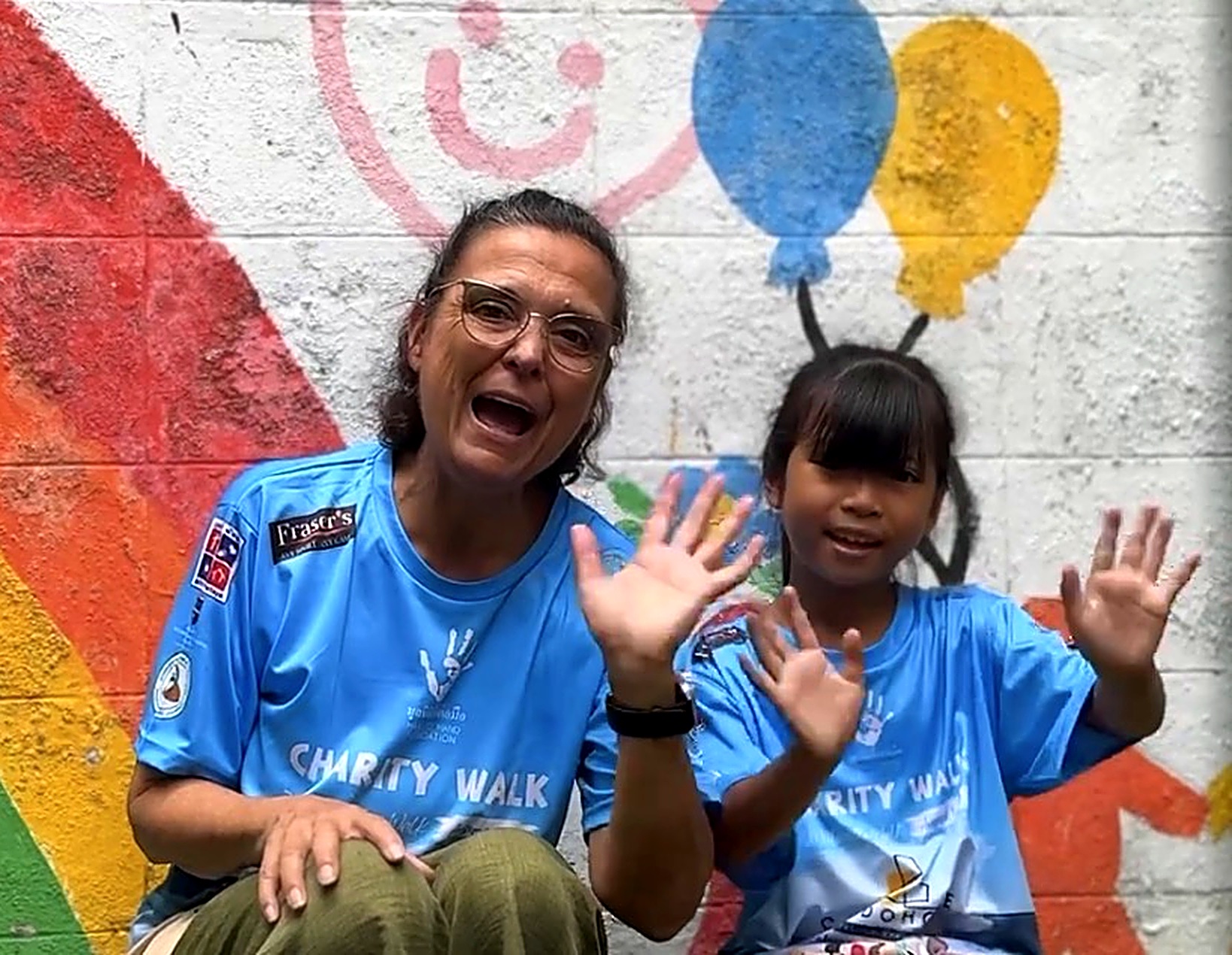 Margaret Grainger, founder of Hand to Hand, with a young girl at the annual Charity Walk
